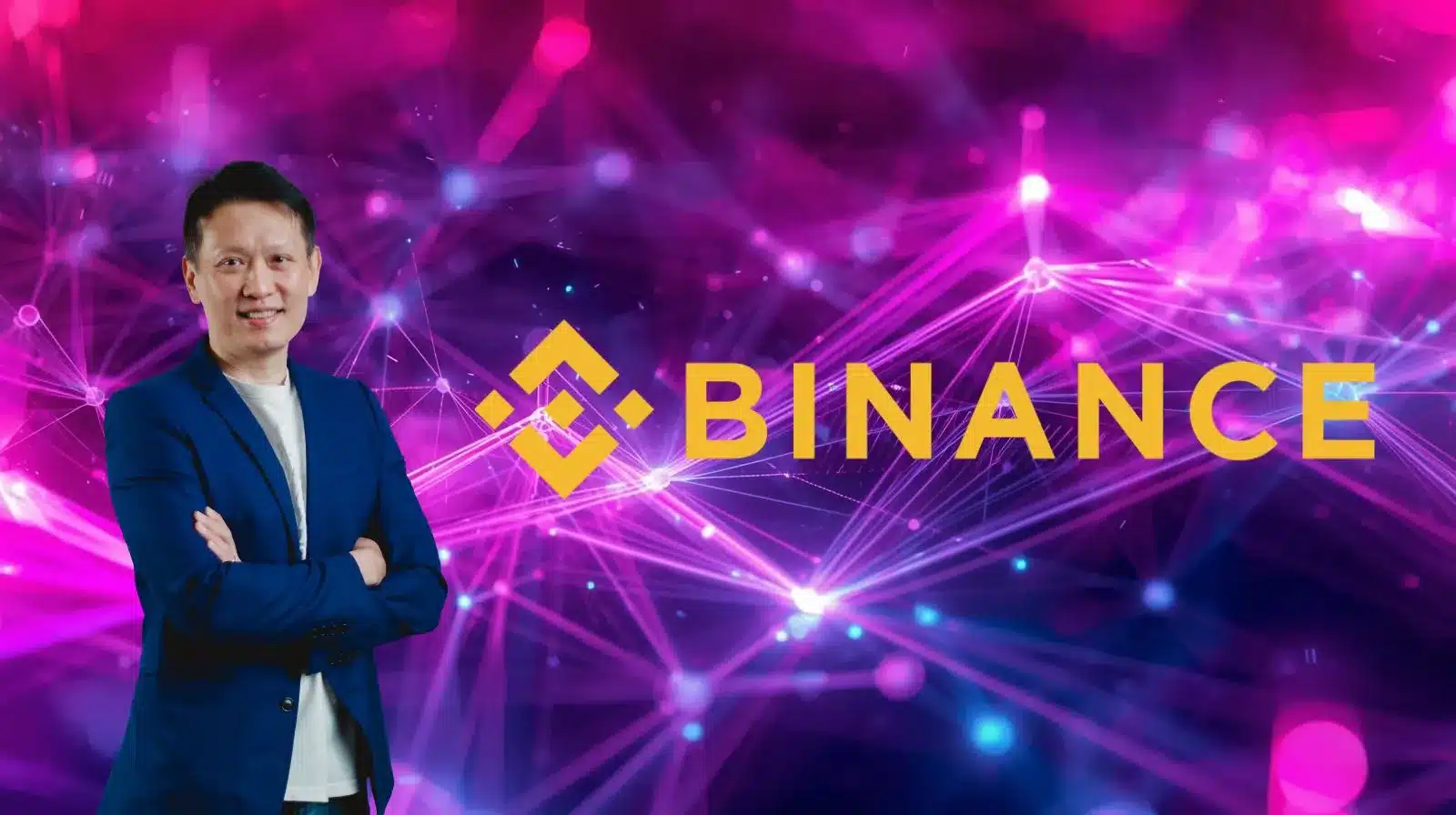 A man in a blue blazer stands with his arms crossed in front of a vibrant pink and purple digital network background. To his right, the yellow Binance logo and the word “BINANCE” are prominently displayed, suggesting a cryptocurrency or blockchain theme